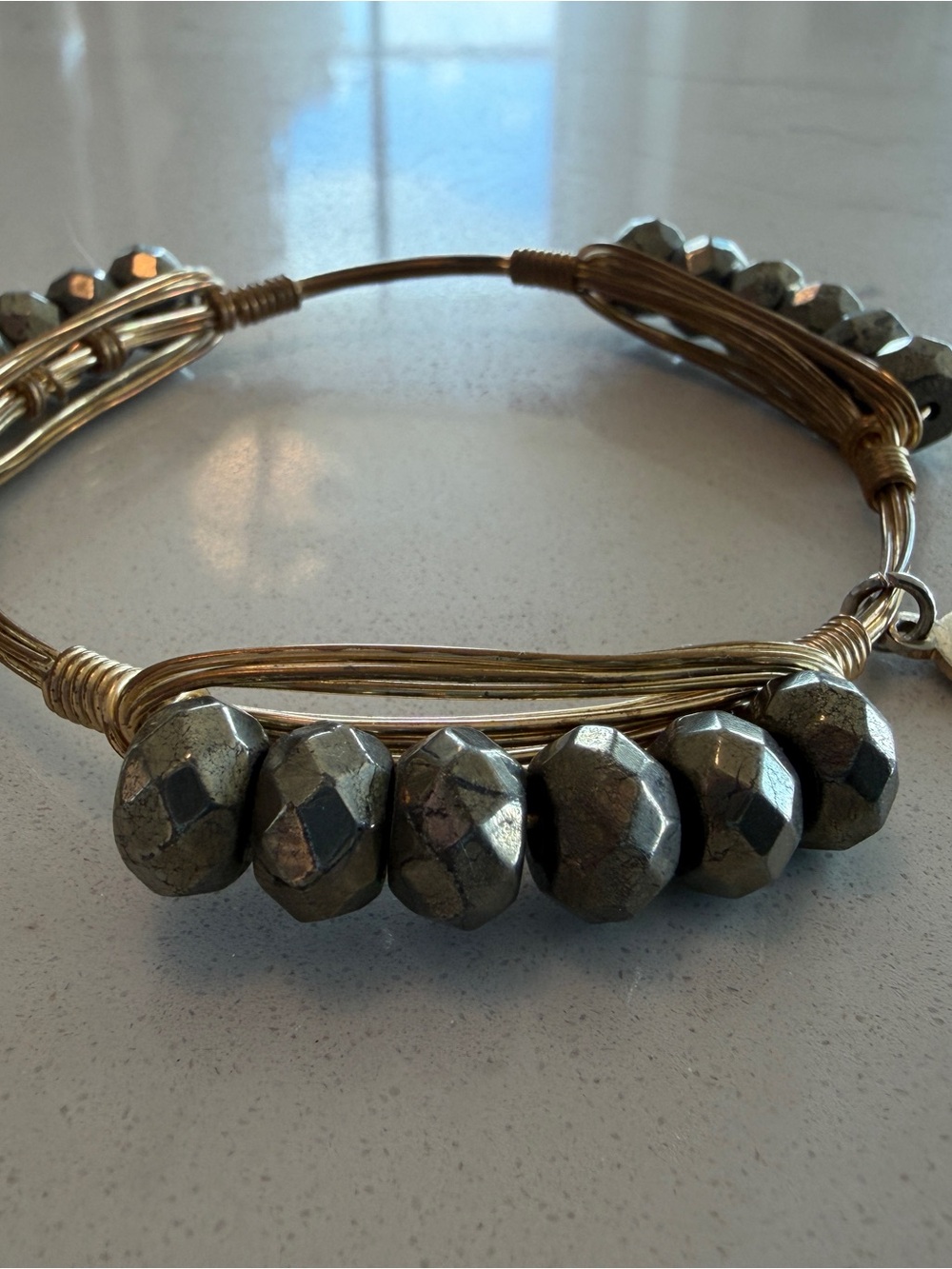 Bourbon and Bowties Gold Wire Bracelet with Metallic Gray Faceted Beads